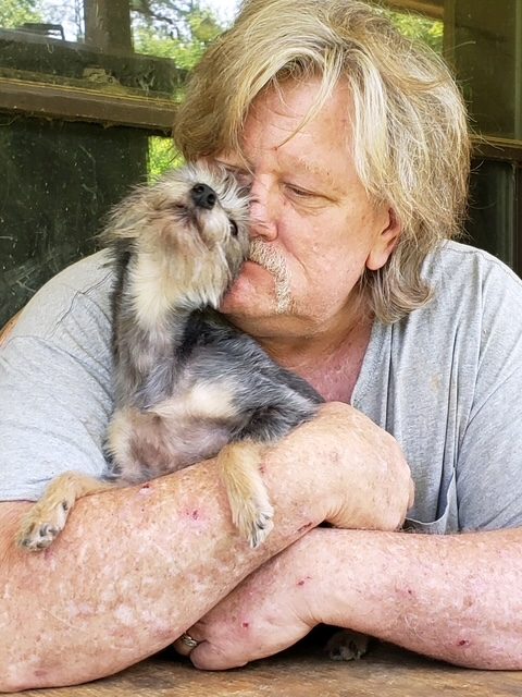 John with a terrier mix pup