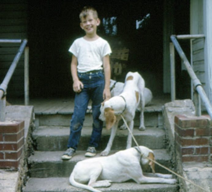 A boy with two dogs, an old family photo